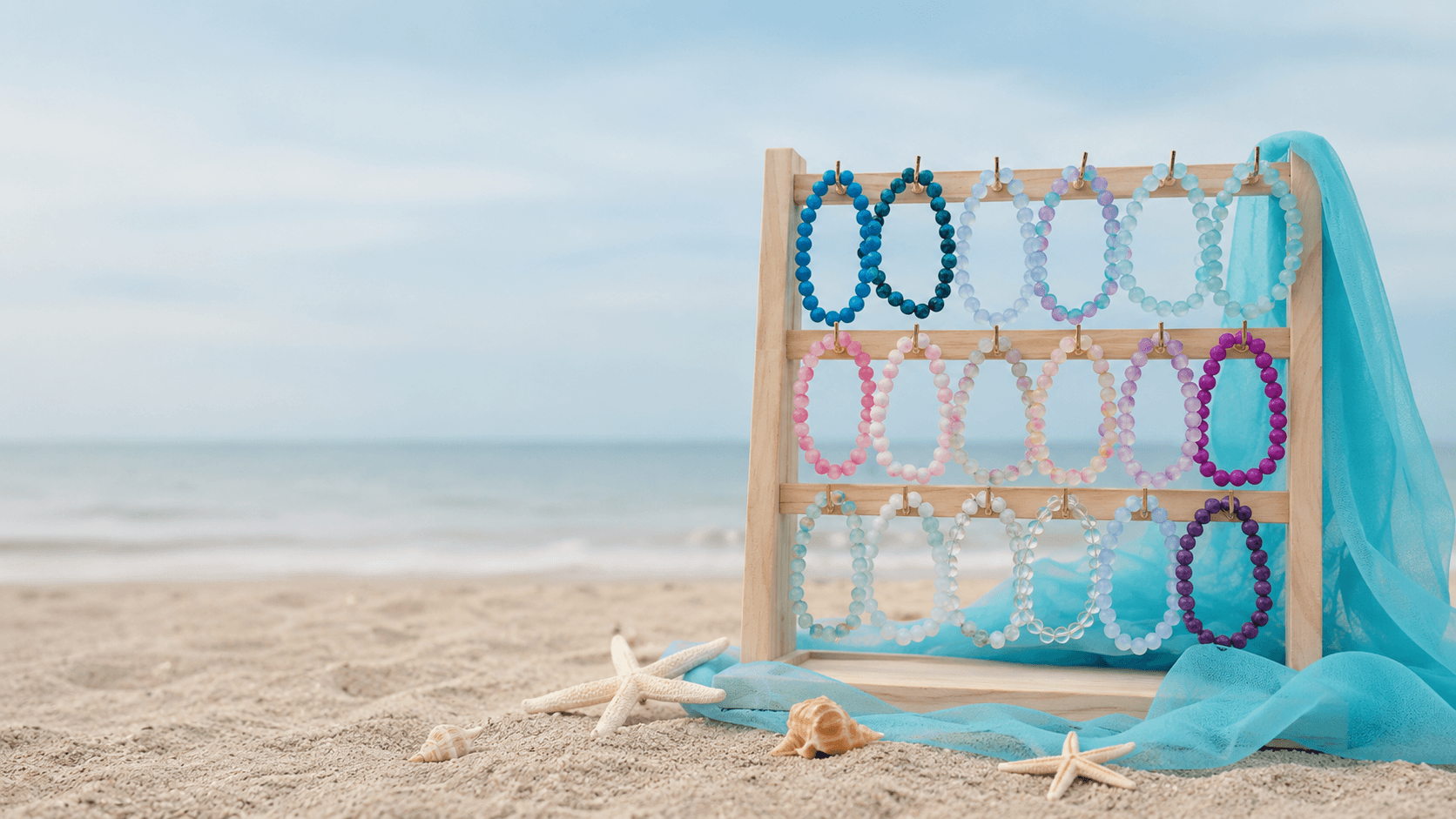 A refined coastal jewelry display featuring layered giftable pieces